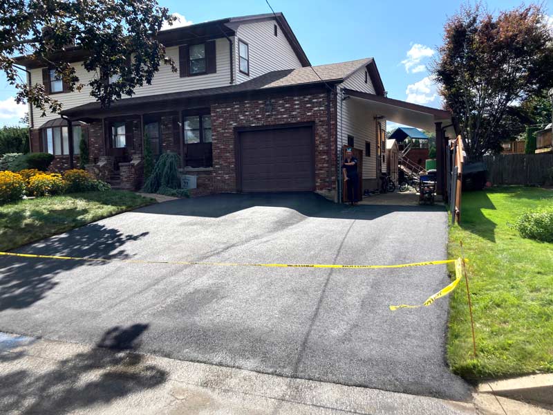 Completed residential asphalt driveway paving project in Cranston, Rhode Island