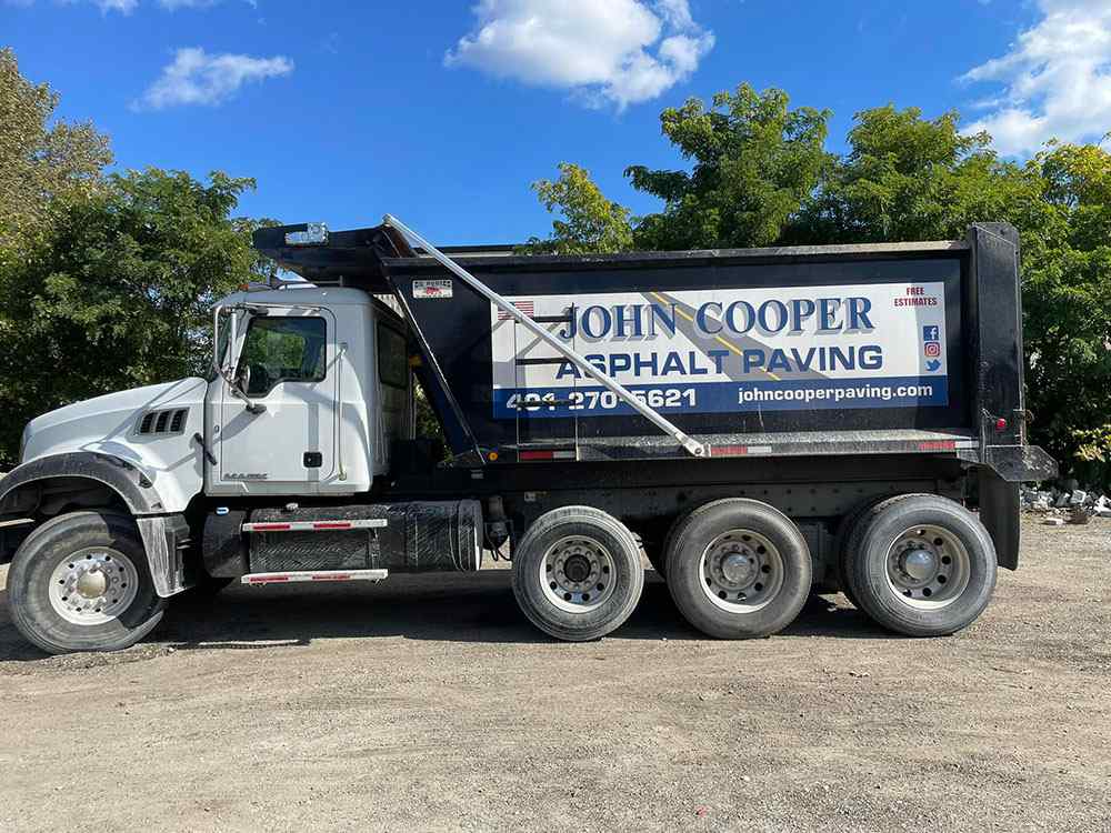 Asphalt dump truck used for paving services, showing contractor equipment fleet in Cranston RI