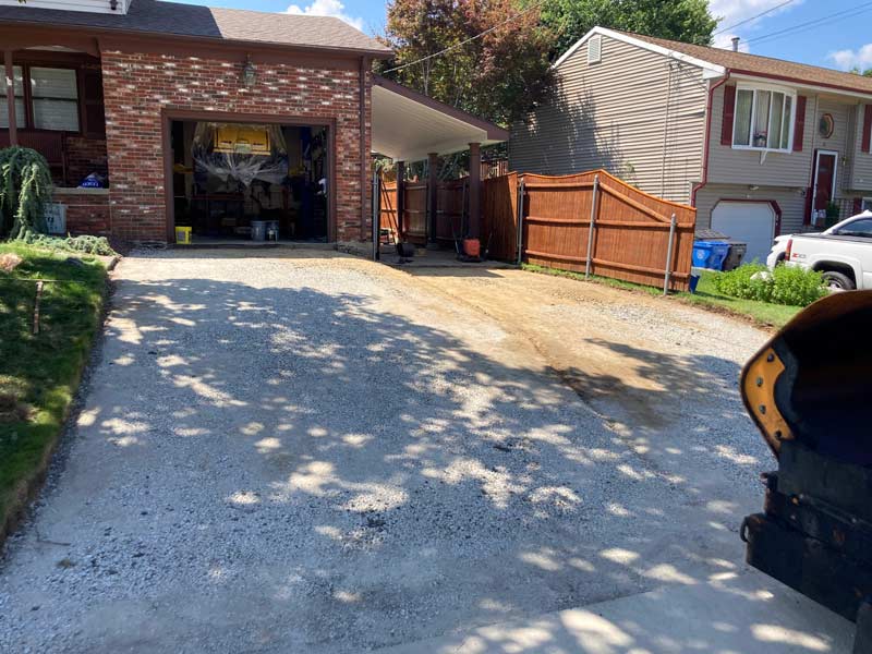 Driveway gravel base prepared for new asphalt driveway installation, paving services in Cranston, RI