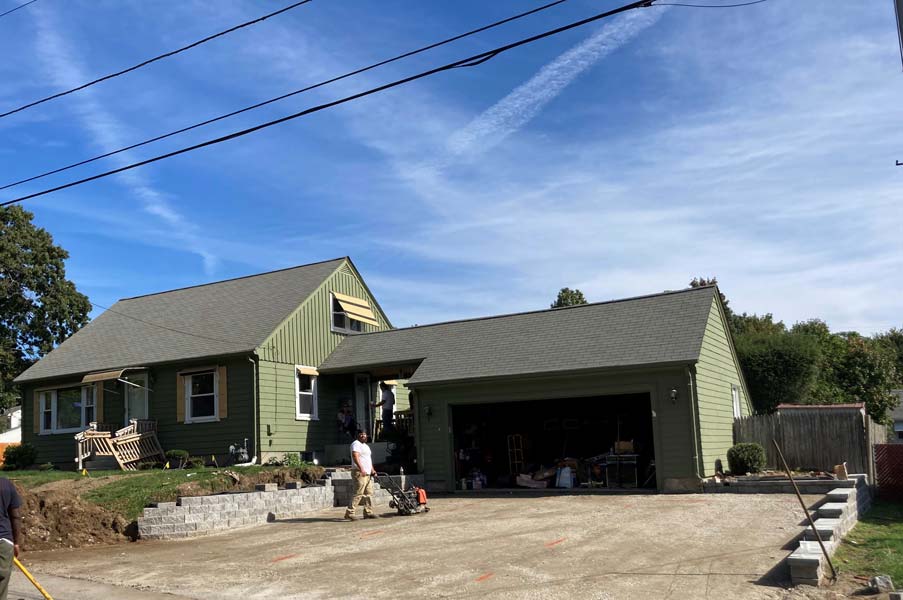 Residential driveway with cracks and surface wear before paving in Cranston, RI