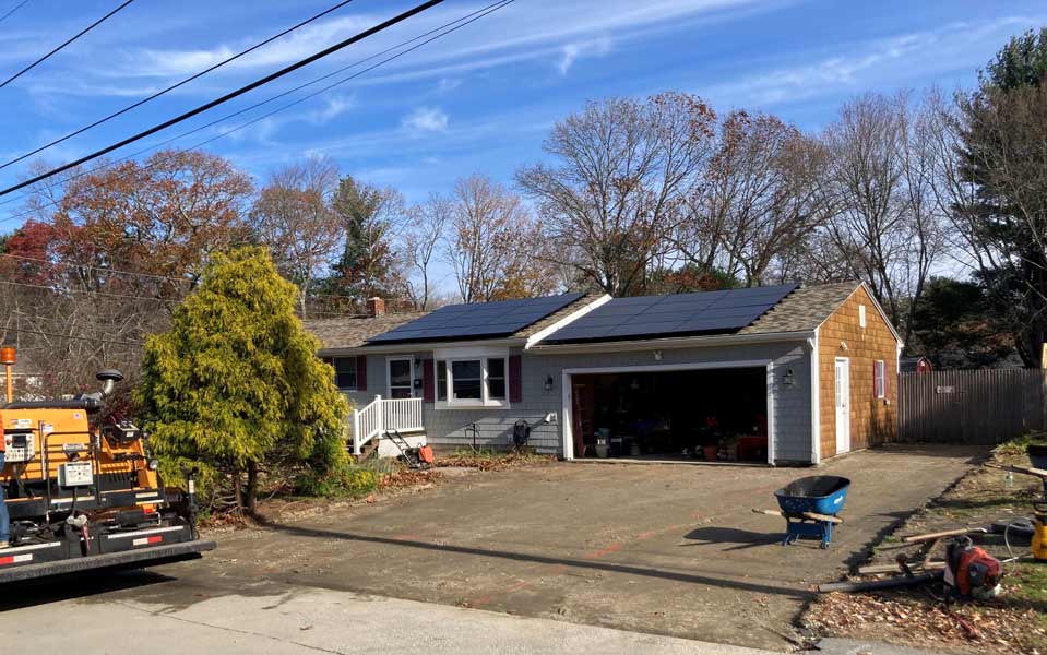 Driveway resurfacing prep with paving equipment for home asphalt installation services in Cranston