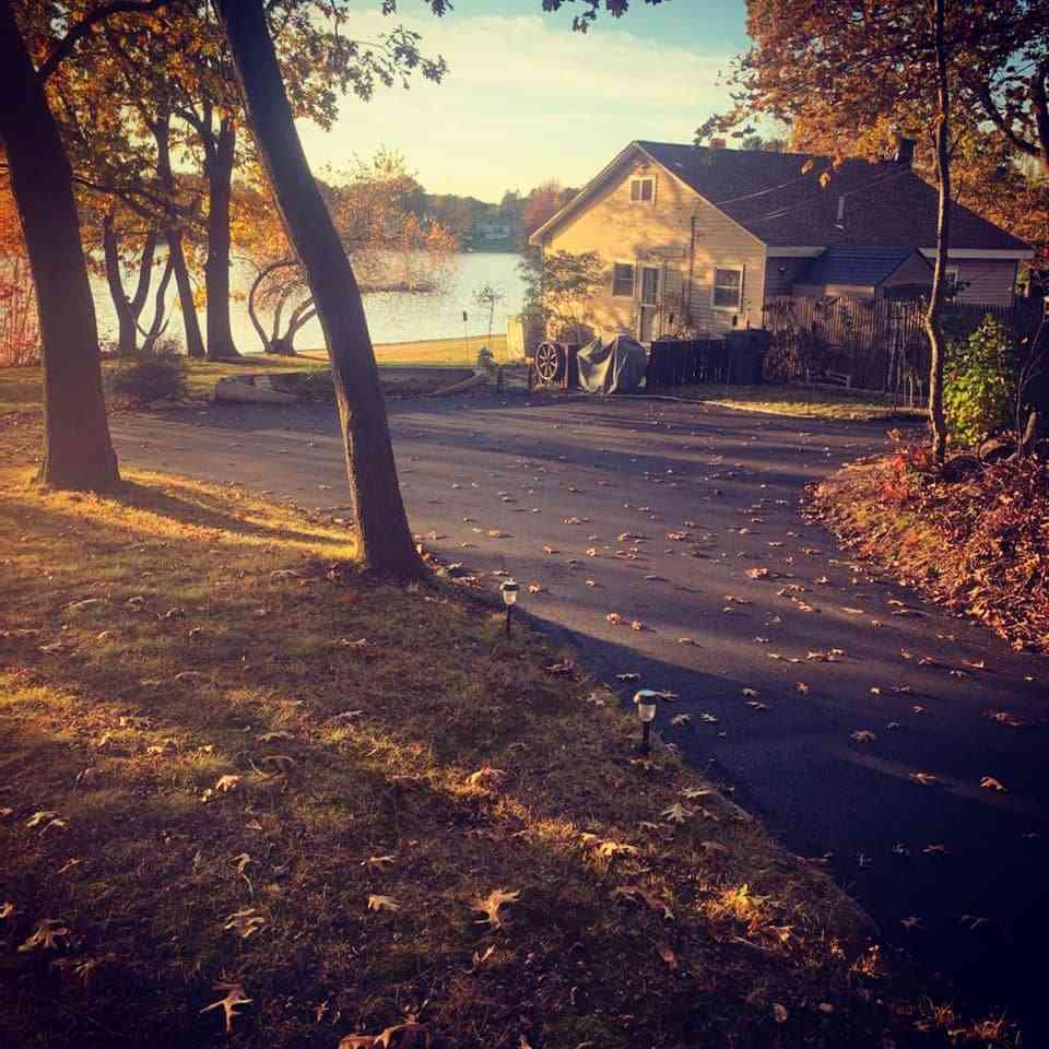 Finished asphalt driveway at lakeside home showing residential paving services in Cranston, RI
