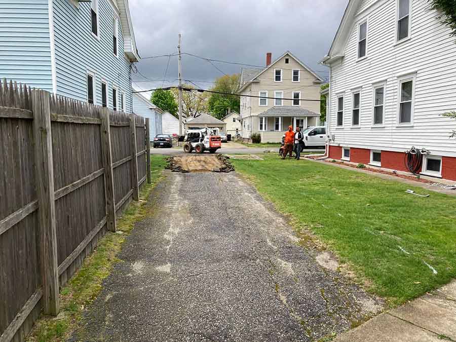 Old driveway removal and excavation before new asphalt paving contractor services in Cranston, RI